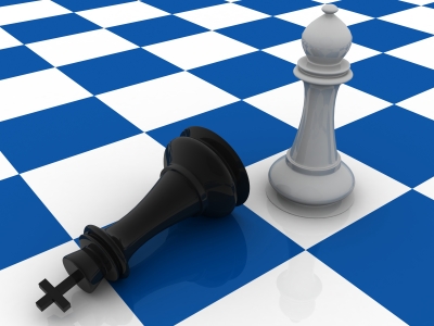 White-And-Black-Chess-Pieces-On-Blue-Checkered-Board
