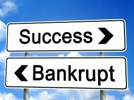 success-bankrupt-signs-pointing-opposite