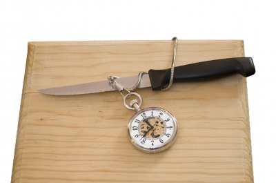 Knife-With-Watch-On-Cutting-Board