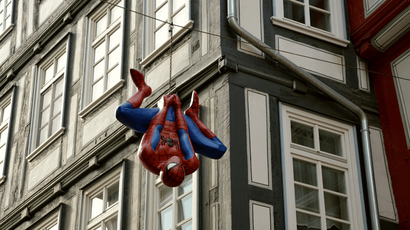 Spiderman hanging in front of building